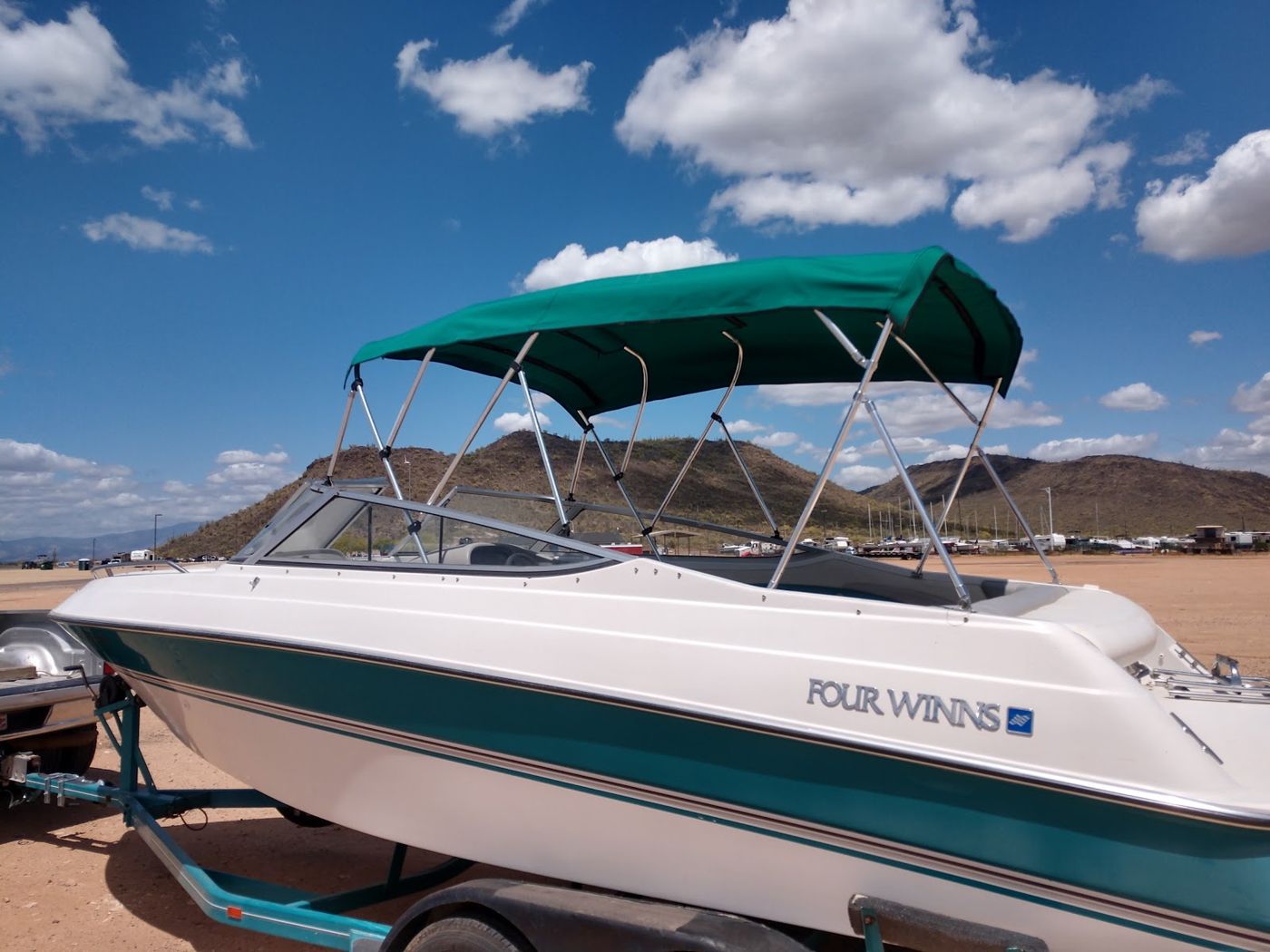 A boat on a trailer in the desert sun